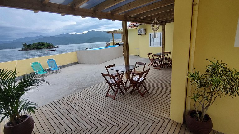 Beira-mar, piscina e vista montanha com pôr do sol